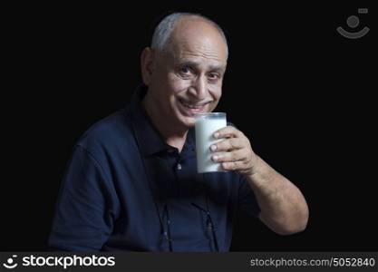 Old man drinking glass of milk