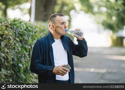 old man drinking water park