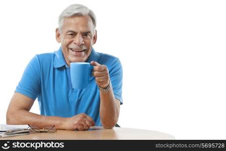 Old man having a cup of tea