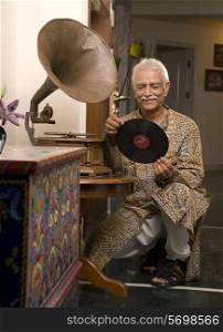 Old man holding a record