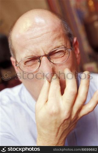Old Man Pinching His Nose