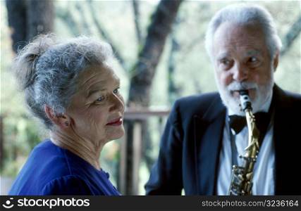 Old Man Playing Saxophone for Old Woman