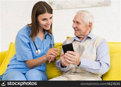 old man showing s phone nurse