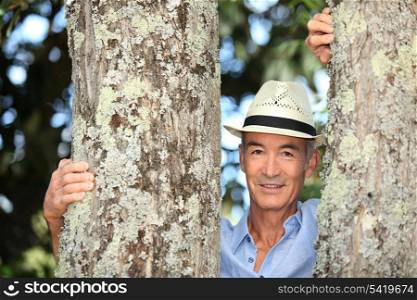 Old man stood between two trees