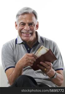 Old man taking money out of a wallet