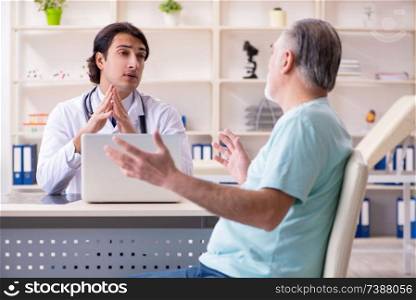 Old man visiting young male doctor 