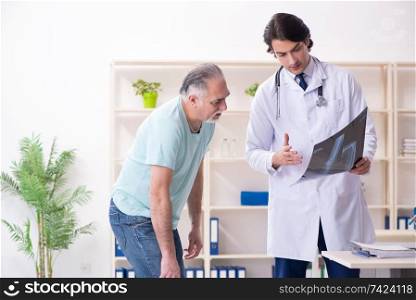 Old man visiting young male doctor 