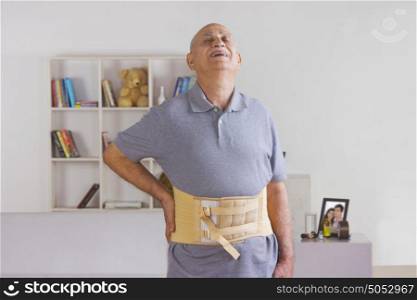Old man wearing support belt