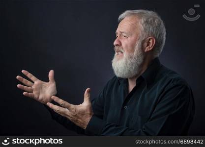 Old man with beard praying for someone and asking for something