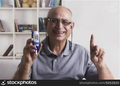 Old man with glucose meter gesturing