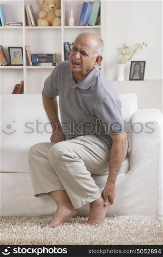 Old man with pain in foot