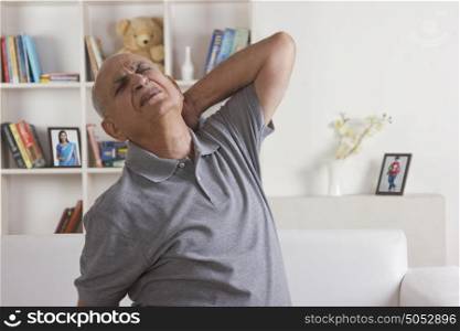Old man with pain in neck