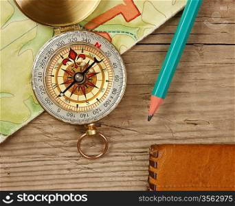 old map and compass on a wooden board