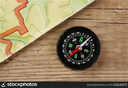 old map and compass on a wooden board