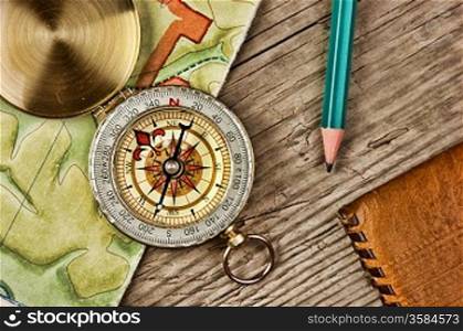 old map and compass on a wooden table