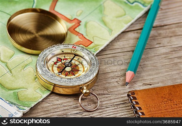 old map and compass on a wooden table