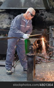old mar welder who works a steel objet