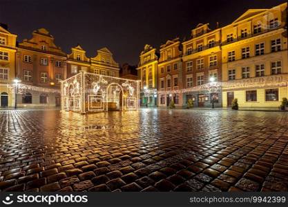 Old market square and colorful facades of medieval houses at night. Poznan. Poland.. Poznan. Old town square at night.