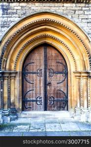Old massive church door with arch
