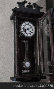 old mechanical clock hanging on the wall