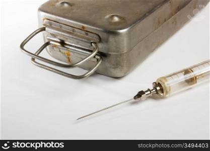old medical syringes and a metal box