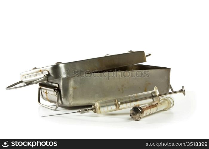 old medical syringes and a metal box isolated on white