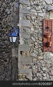 Old medieval lantern on a stone wall. metal streetlight