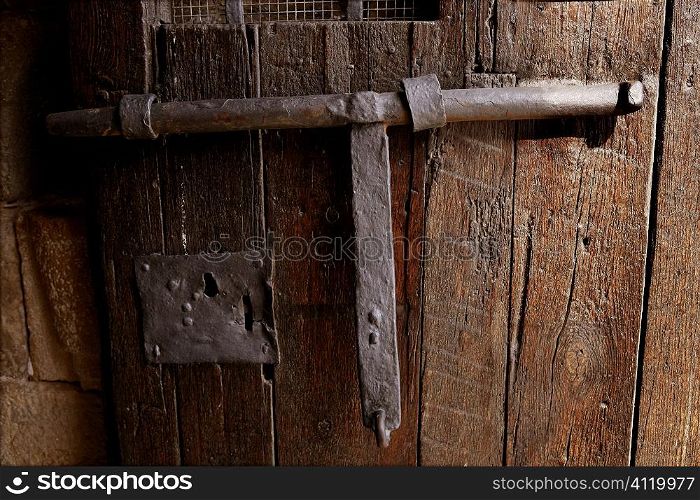 Old medieval lock on wooden castle door