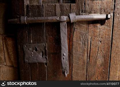 Old medieval lock on wooden castle door