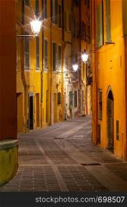 Old medieval narrow street in the historical part of the city at night. Menton. France. Cote d'Azur.. Menton. Old narrow street in the historic part of the city.
