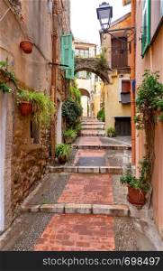 Old medieval narrow street in the historical part of the city. Menton. France. Cote d'Azur.. Menton. Old narrow street in the historic part of the city.