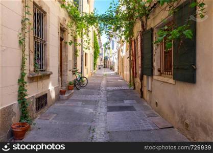 Old medieval street in the early morning. France. Arles. Provence. Arles. Old narrow street in the historic center of the city.