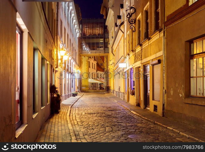 Old medieval street in the historic center of Riga at night.. Riga. Old street at night.