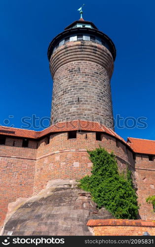 Old medieval tower in the historical part of the city on a sunny day. Nuremberg. Bavaria. Germany.. Historical part of the old town of Nuremberg, Franconia, Germany.