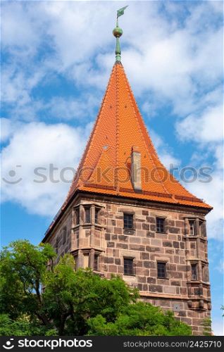 Old medieval tower in the historical part of the city on a sunny day. Nuremberg. Bavaria. Germany.. Historical part of the old town of Nuremberg, Franconia, Germany.