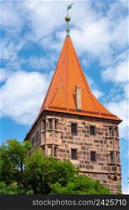 Old medieval tower in the historical part of the city on a sunny day. Nuremberg. Bavaria. Germany.. Historical part of the old town of Nuremberg, Franconia, Germany.