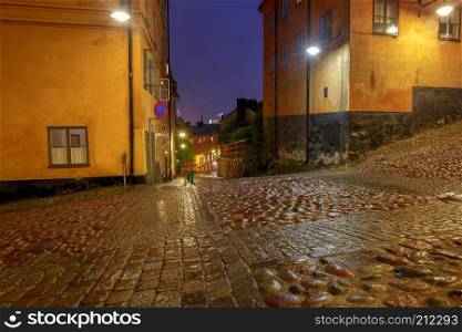 Old medieval traditional street in the night illumination. Stockholm. Sweden.. Stockholm. Old street at night.