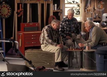 Old Men Playing Chess In Garage
