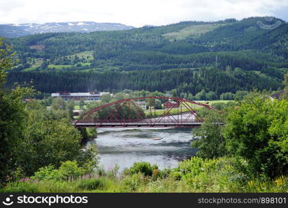 Old metal arch bridge and river in Norway