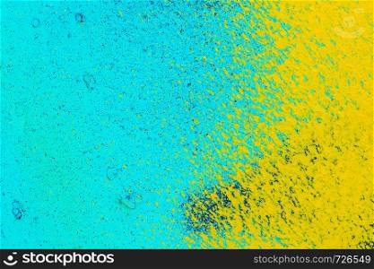 old metal blue surface with yellow paint. Abstract background, texture