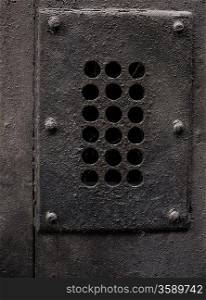 Old metal cover with holes
