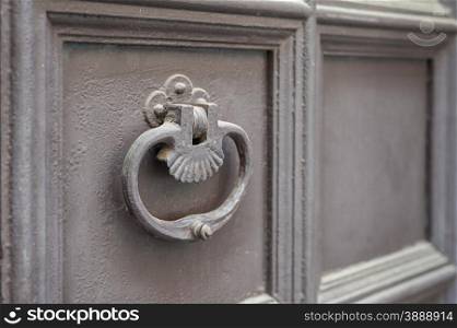 Old metal knocker on a door