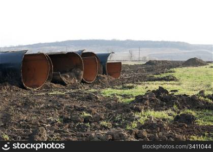 Old metal pipes dismantled for scrap placed on land