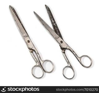 Old metal scissors isolated on white background.