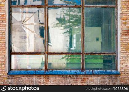 Old metallic window surrounded by red bricks in a soviet building of Kiev, Ukraine