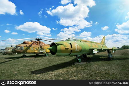 Old military plane and helicopter at the airport