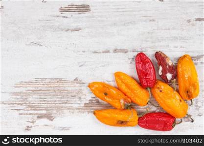 Old, moldy and wrinkled peppers. Concept of unhealthy, decompose, spoiled vegetable. Copy space for text or inscription. Old, moldy and wrinkled peppers. Unhealthy, decompose, spoiled vegetable. Copy space for text