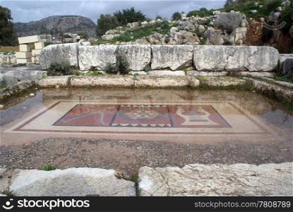 Old mosaic, water and ruins of oldtemple in Letoon, West Turkey