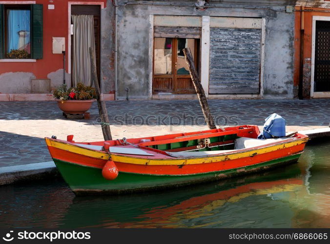 Old motorboat on the street in Burano, Italy. Motorboat in Burano