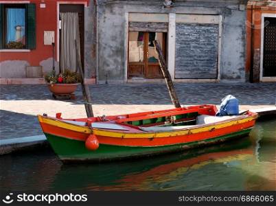 Old motorboat on the street in Burano, Italy. Motorboat in Burano